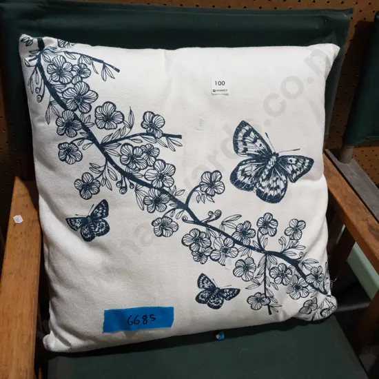 white cushion with botanical print