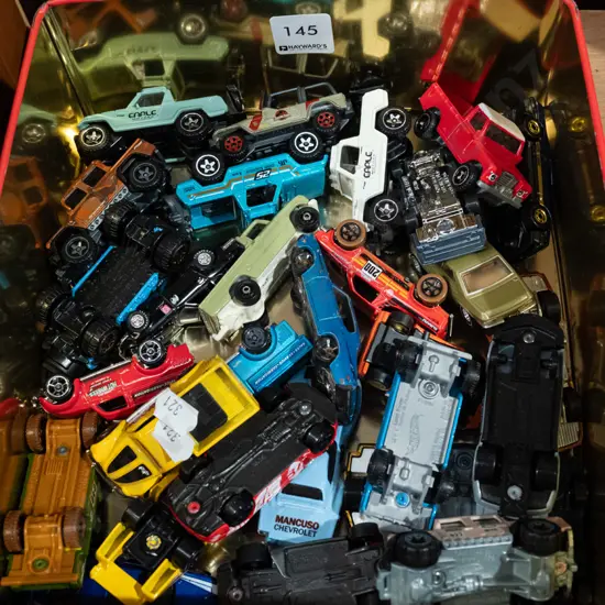 cake tin and toy vehicles