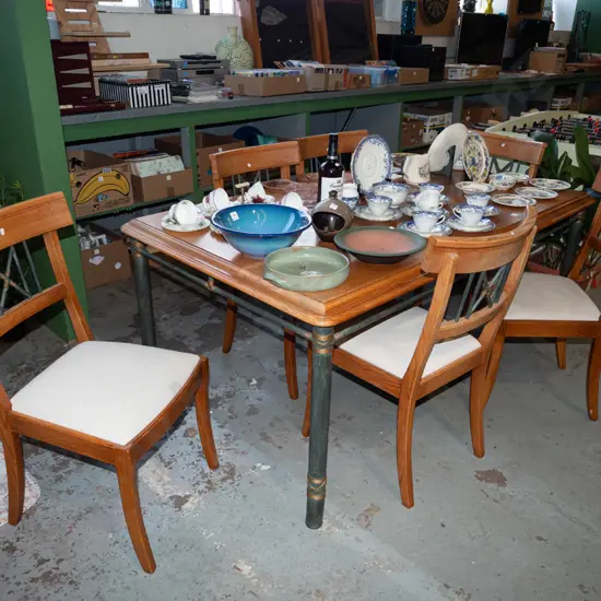 solid oak dining table on green  metal base with 6 metal backed and upholstered chairs