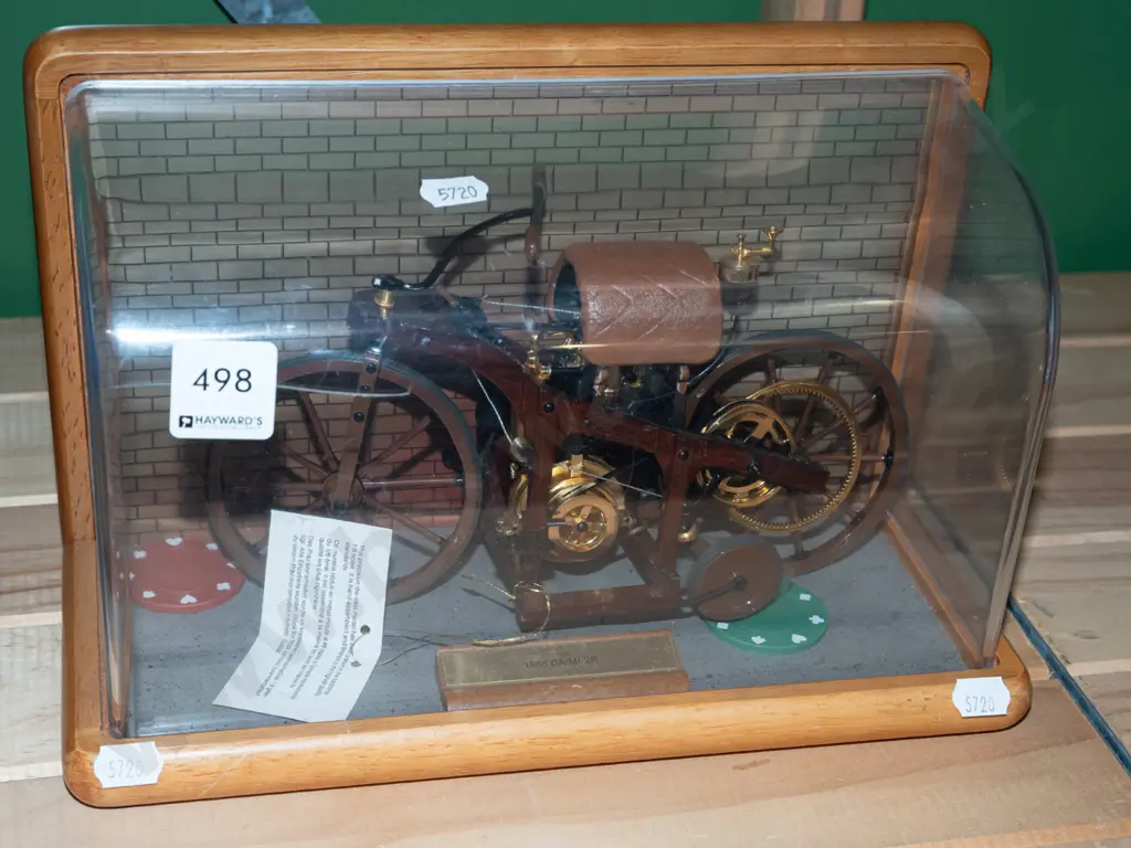model of 1885 Daimler motorcycle in display case Image 1++