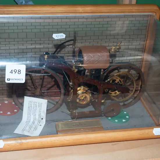model of 1885 Daimler motorcycle in display case