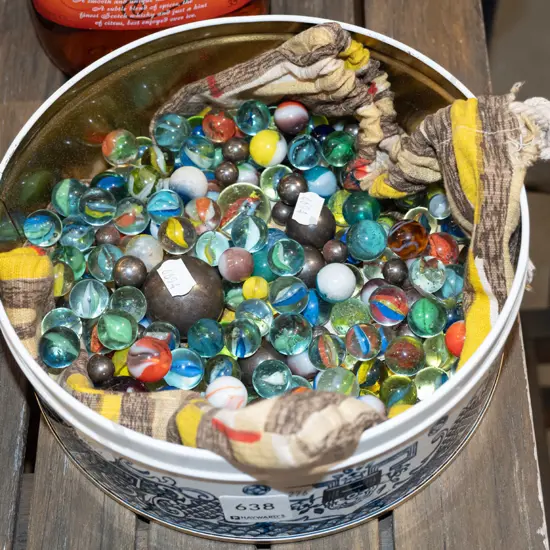 tin of various marbles