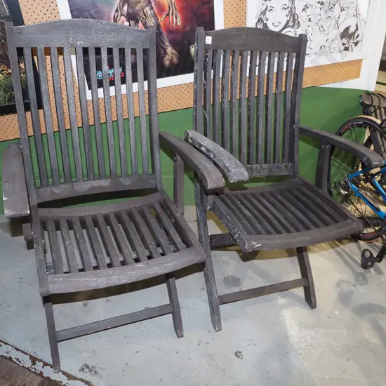 2x dark stained wooden foldaway outdoor chairs