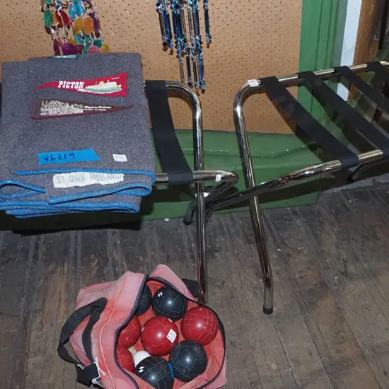 pair of chrome and black strapping luggage stands