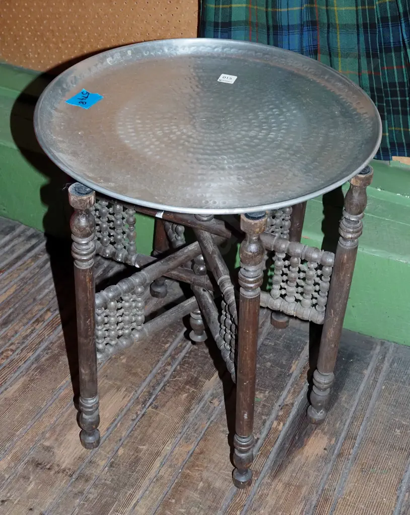 beaten alloy circular tray on turned wooden collapsable stand Image 1++