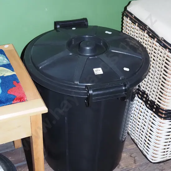 black plastic lidded rubbish bin
