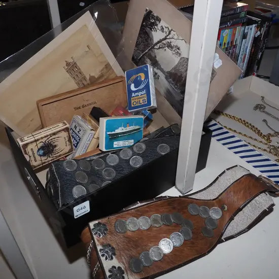 box; belt with coins, playing cards, black and white photographs