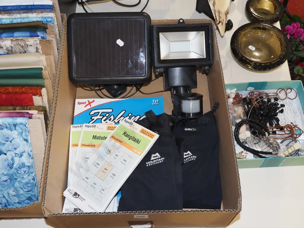 box; topographical maps, fishing books, solar panel light, gaiters etc Image 1++