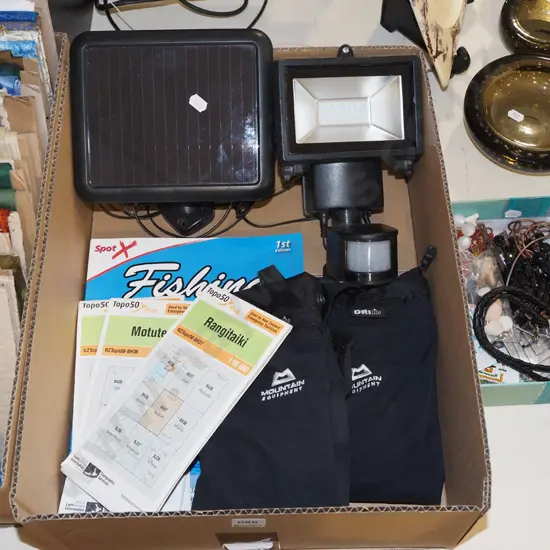 box; topographical maps, fishing books, solar panel light, gaiters etc