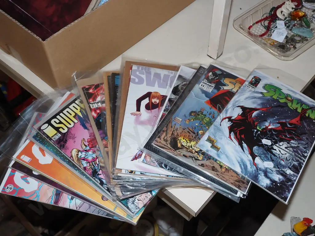 stack of graphic novels in plastic bags Image 1++