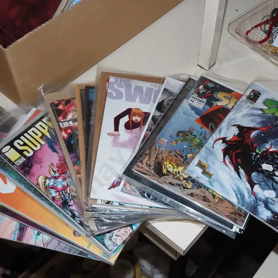 stack of graphic novels in plastic bags