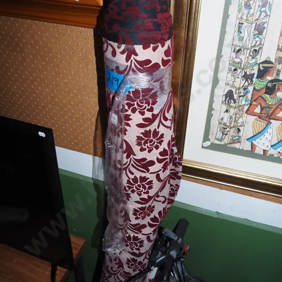bolt of red and white floral upholstery fabric