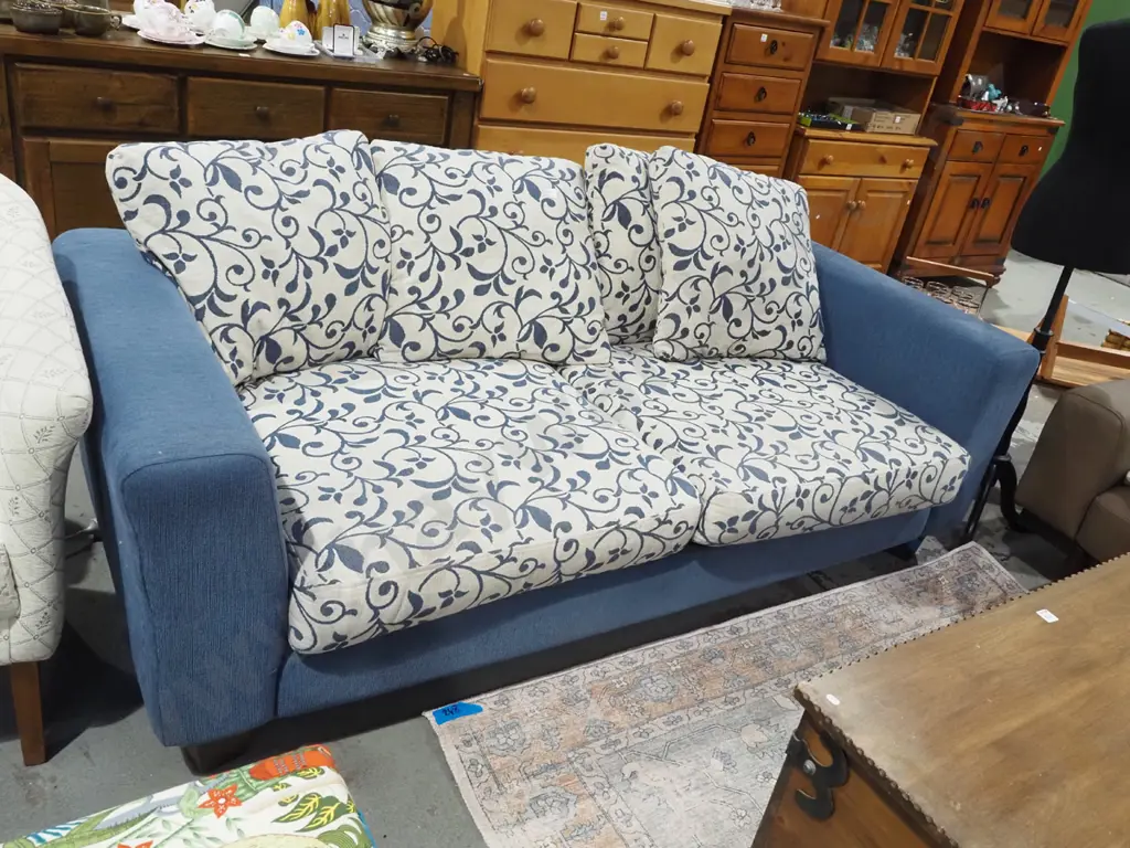 blue upholstered 3 seater settee with matching floral cushions Image 1++