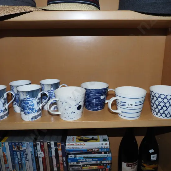 shelf of blue and white coffee cups