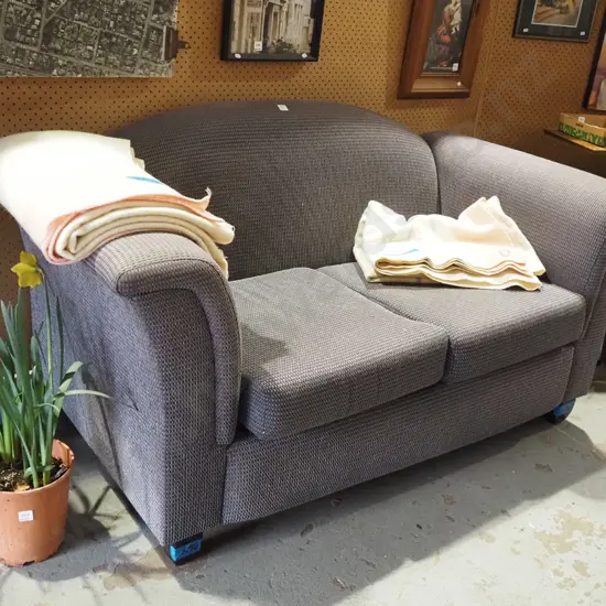grey upholstered 2 seater settee