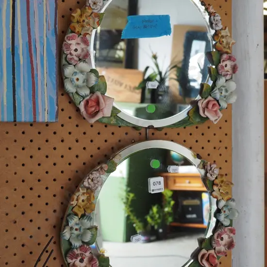 2x bevelled edge circular wall mirrors with flowers to edges - some damage and residue