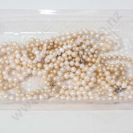 tray; pearl? necklaces