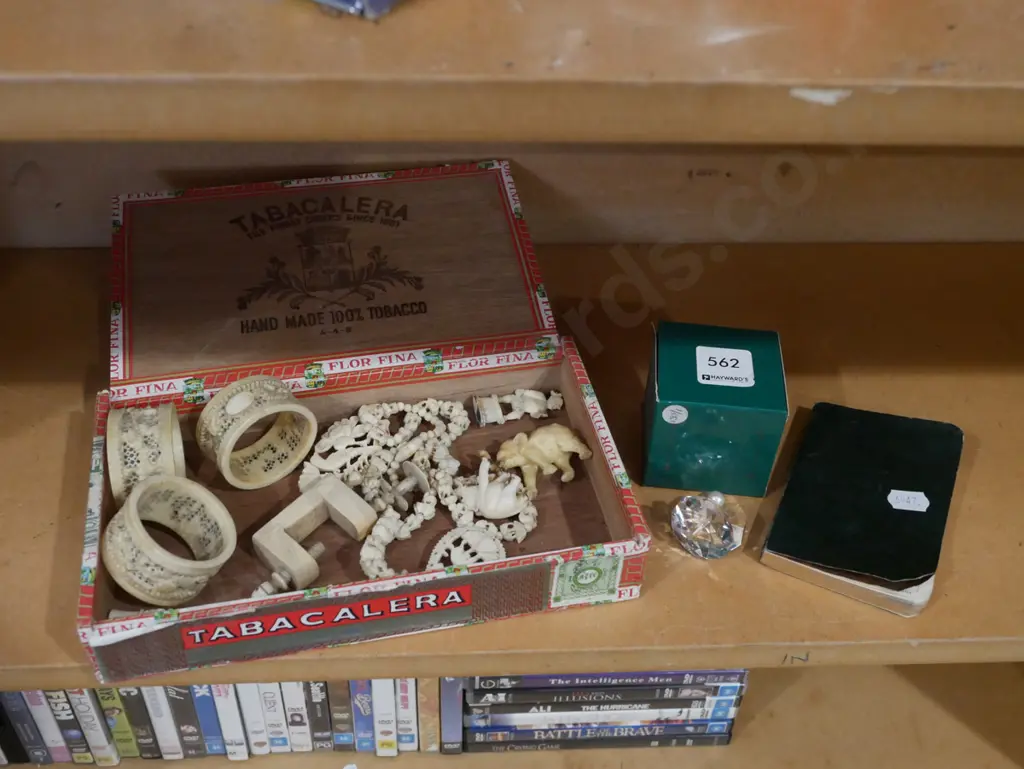 cigar box of various intricately carved bone items, small crystal ornament and vintage promotional calendar/diary Image 1++