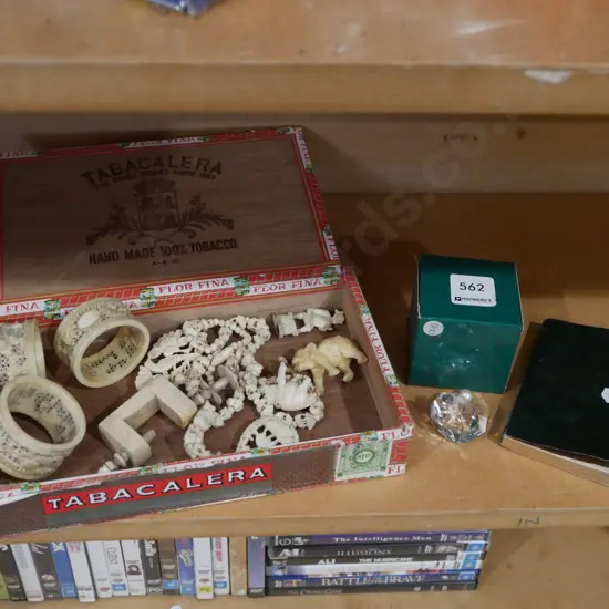 cigar box of various intricately carved bone items, small crystal ornament and vintage promotional calendar/diary