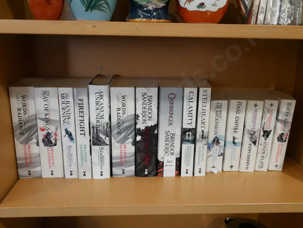 shelf of Brandon Sanderson books Image 1++