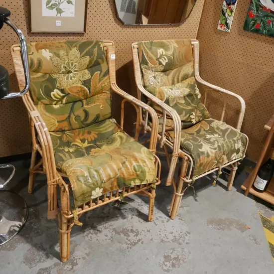 pair of matching cane armchairs with floral cushions