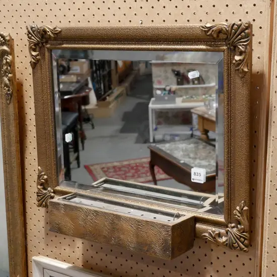 gilt framed wall mirror with mounted vase at base