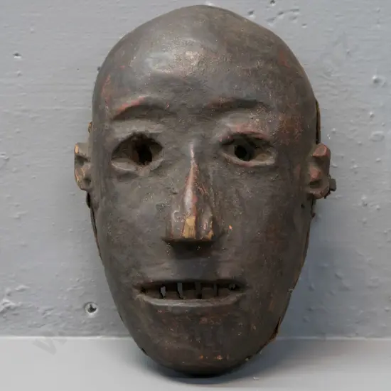 carved wood Fipa mask (Tanzania?) with earth pigment, remnant fabric liner around edge, has some chips H-230 W-170