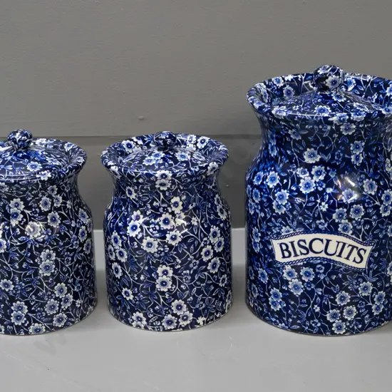 3 Burleigh Calico cobalt blue lidded canisters - one with Ballantynes label, larger marked "Biscuits" is H-210 D-140