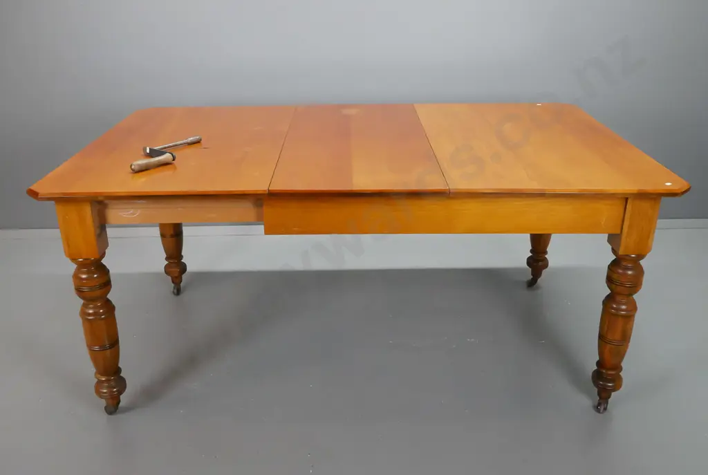 colonial New Zealand kauri and rimu turned-leg wind-out dining table with one leaf, on porcelain casters - minor wear Image 1++