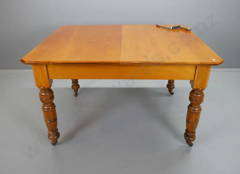 colonial New Zealand kauri and rimu turned-leg wind-out dining table with one leaf, on porcelain casters - minor wear Image 1++