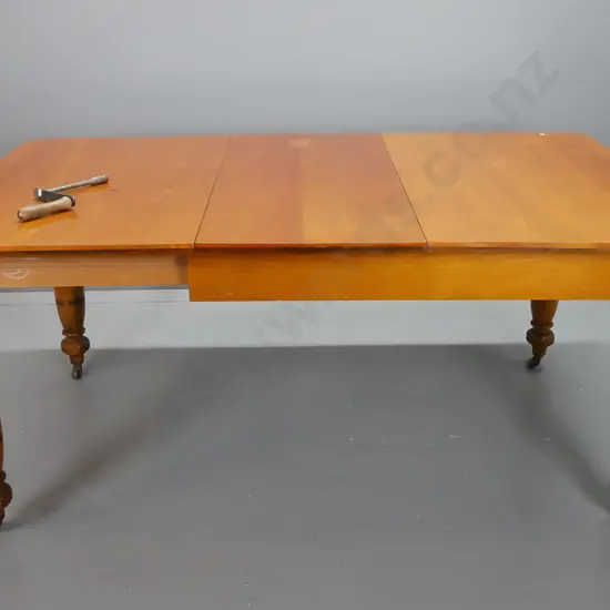 colonial New Zealand kauri and rimu turned-leg wind-out dining table with one leaf, on porcelain casters - minor wear