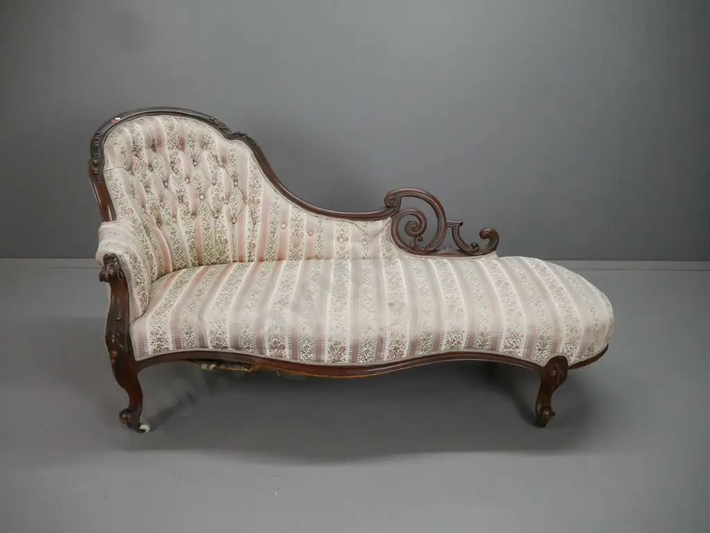 Victorian walnut chaise longue with shaped carved back, scrolling ends, serpentine front on carved cab legs, deep button Image 1++