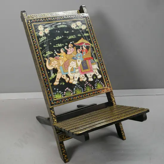 Indian 2-piece collapsible chair with hand painted scenes and gilt decoration over black - some