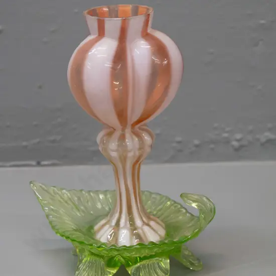 vintage uranium and pink glass vase with lobed top on green uranium 5-footed lead shaped base. 3 feet are chipped. H-180