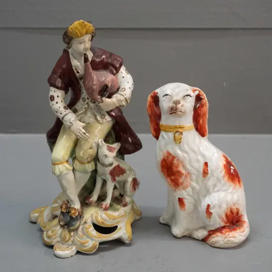 antique seated musician with dog figure - note on base attributes to Chelsea Derby - and a small Staffordshire spaniel.