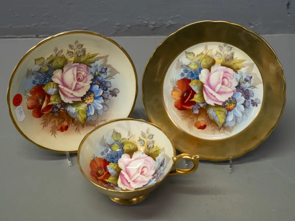 Aynsley hand painted floral and heavy gilt trio, each piece signed J. A. Bailey Image 1++