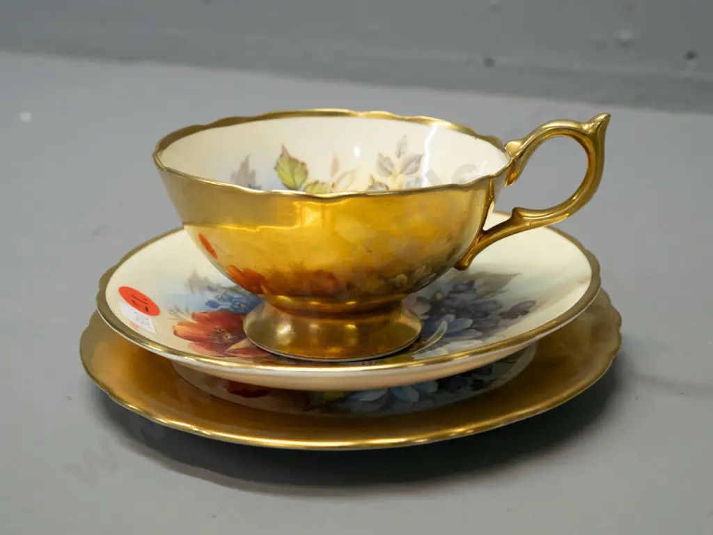 Aynsley hand painted floral and heavy gilt trio, each piece signed J. A. Bailey Image 1++