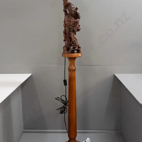 standard lamp made from Chinese carved hardwood figure attached to colonial turned kauri and rimu base, with electric