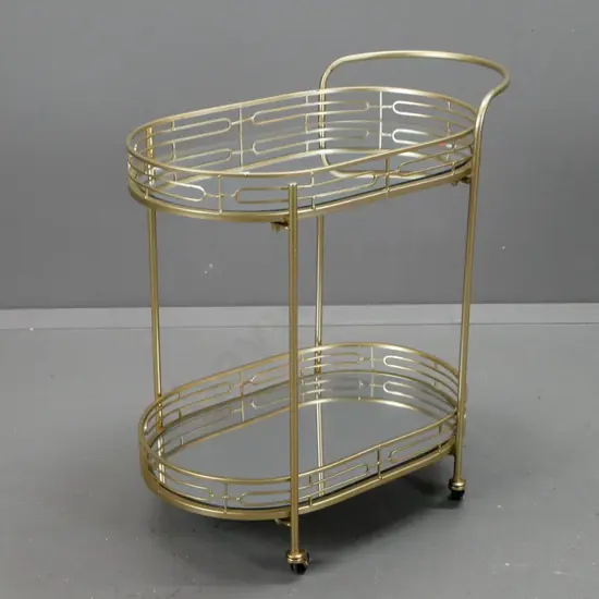 retro style tea or drinks trolley on plastic wheel casters, powder coated gold on metal frame, mirrored glass
