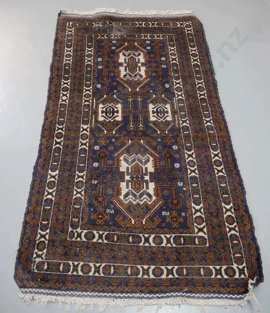 Persian style hand knotted wool floor rug - dark blue, ivory and brown - worn fringe and one small area torn or shredded Image 1++