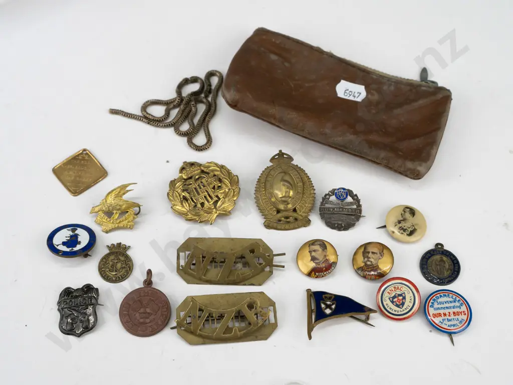 assorted New Zealand military, NZE and other hat and uniform badges, souvenir buttons, etc. with worn leather pouch incl Image 1++