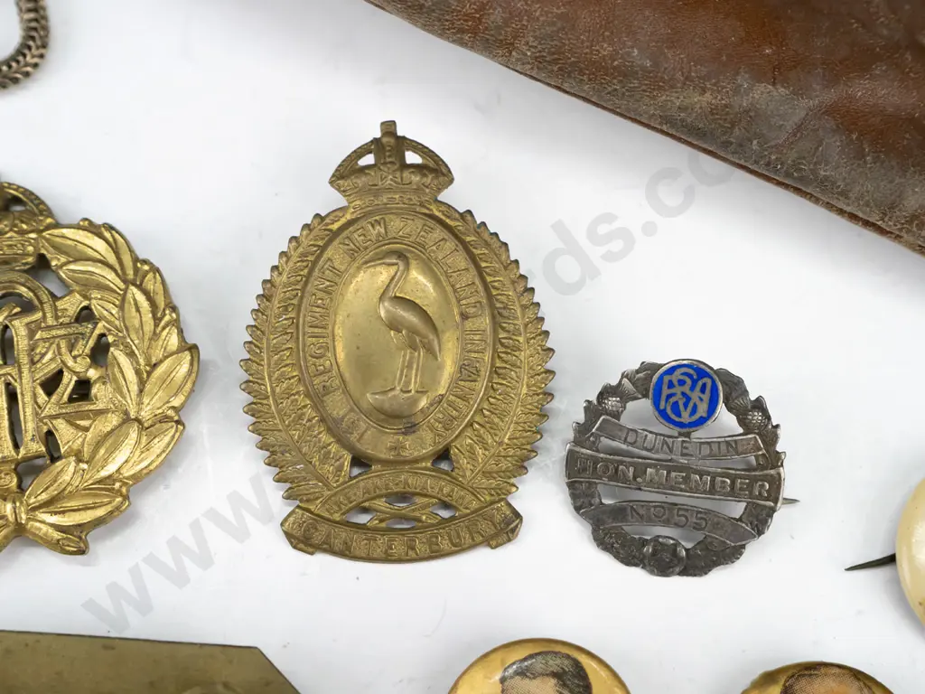 assorted New Zealand military, NZE and other hat and uniform badges, souvenir buttons, etc. with worn leather pouch incl Image 1++