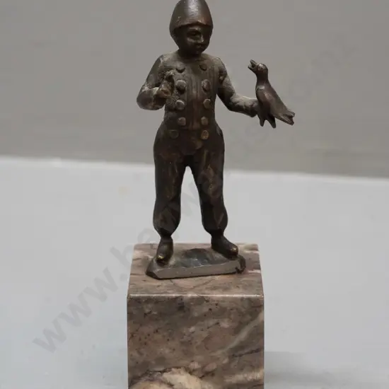 small bronze figure on polished stone base - boy with bird - hard to read markings, see photos H-125