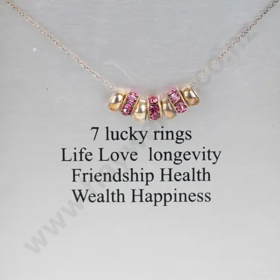 silver necklace with 7 rings stamped 925