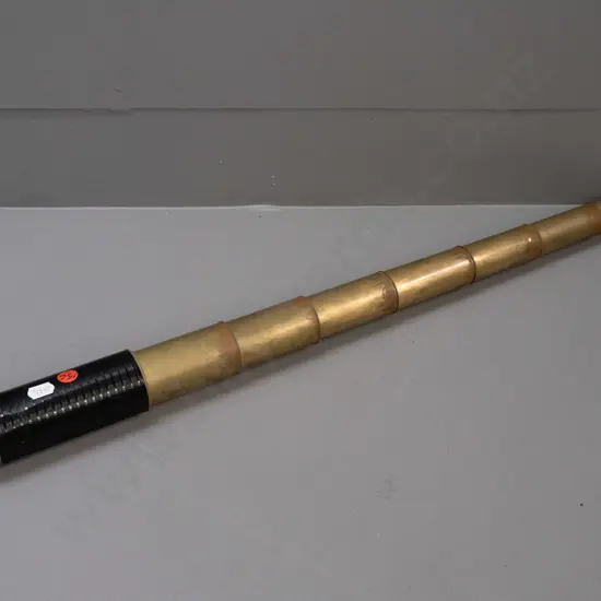 vintage brass pocket telescope with 8 sections, hard black textured covering, eyepiece section marked Elliott 56 Strand