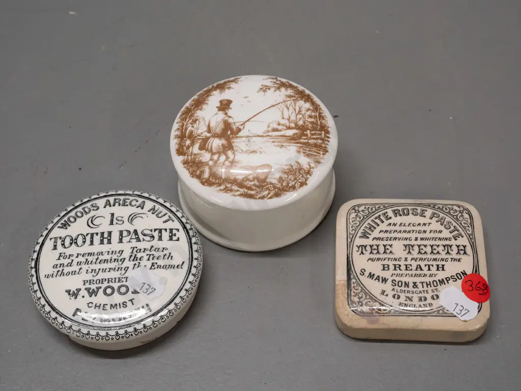 2 English toothpaste lids - White Rose and Wood's Areca Nut - and a lidded canister with fishing scene on lid, marked Image 1++