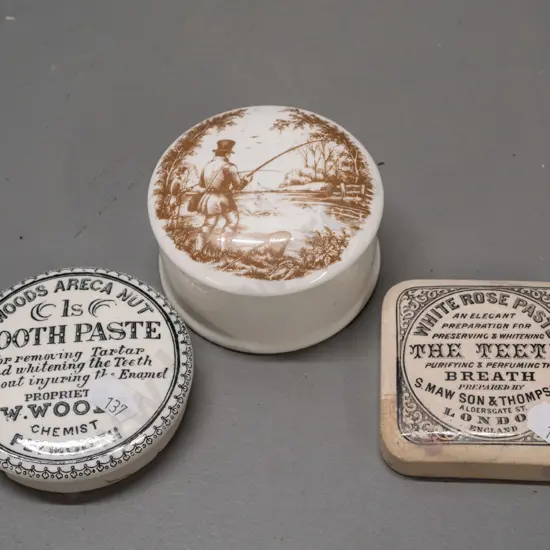 2 English toothpaste lids - White Rose and Wood's Areca Nut - and a lidded canister with fishing scene on lid, marked