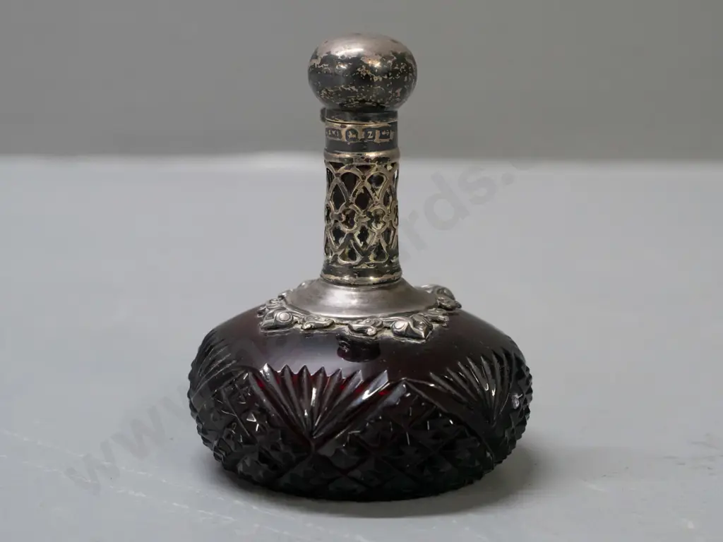 vintage ruby cut glass scent bottle with hallmarked sterling silver pierced collar and lid, small glass stopper. Image 1++