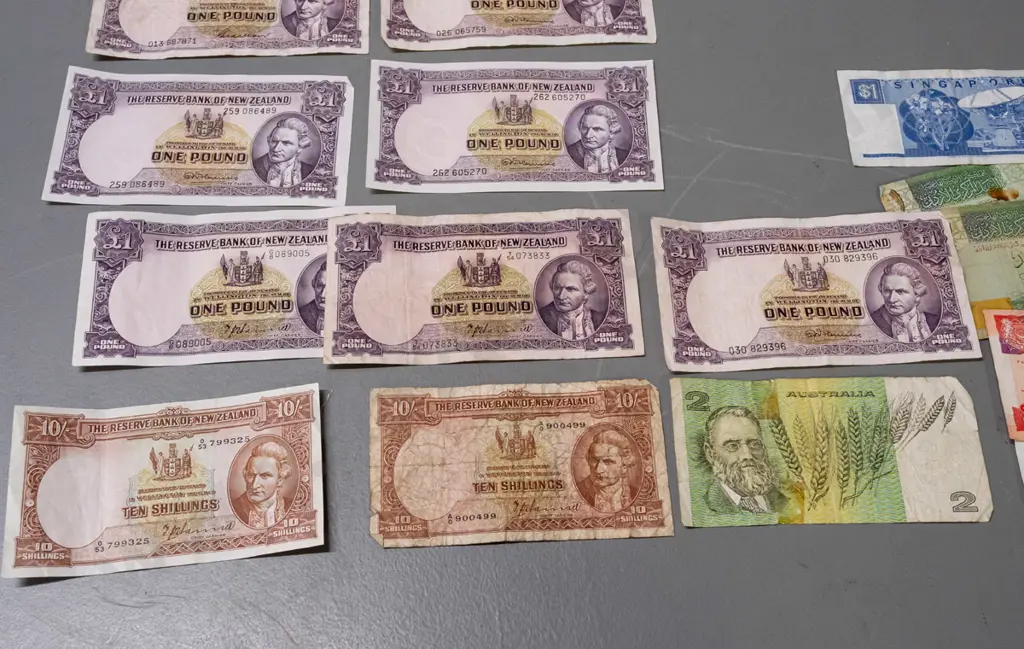 7 Reserve Bank of New Zealand 1 pound notes, 2 10-shilling notes, and some Singapore, Australia and other notes, varying Image 1++