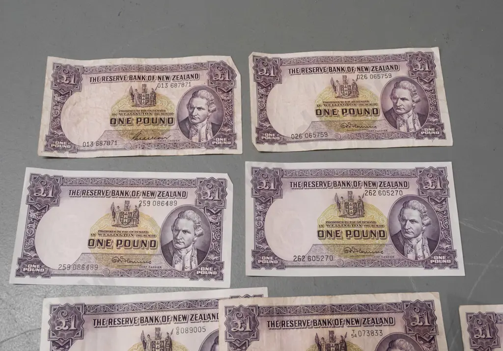 7 Reserve Bank of New Zealand 1 pound notes, 2 10-shilling notes, and some Singapore, Australia and other notes, varying Image 1++